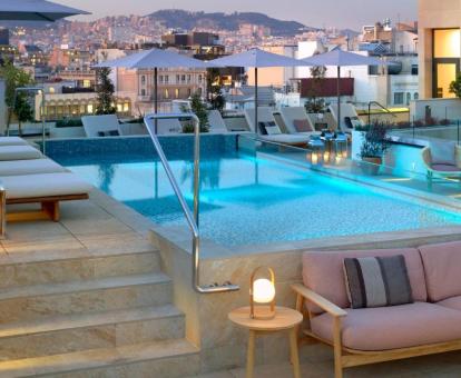 Terraza en la azotea con piscina y vistas a la ciudad de este hotel con encanto.